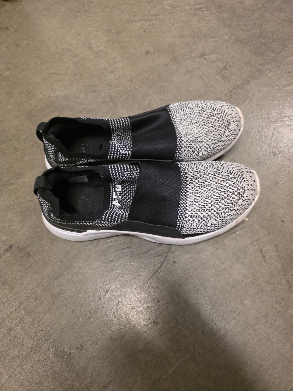 black and white APL Athletic Propulsion Labs TechLoom Bliss slip-on sneakers